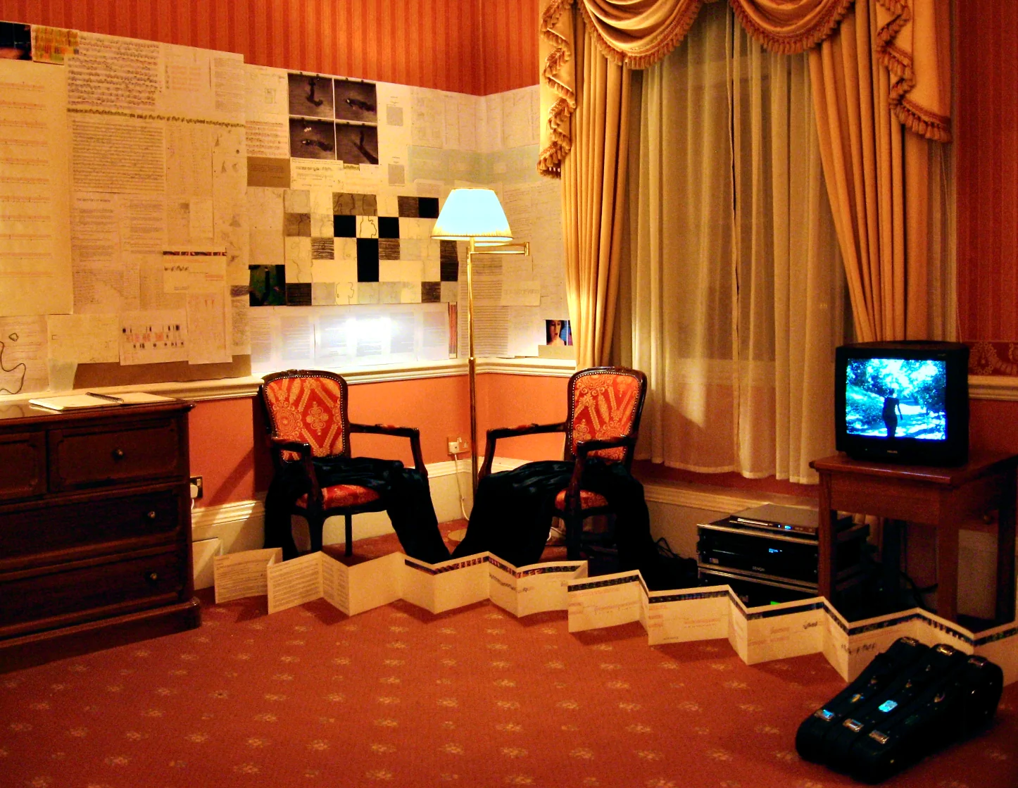 Installation view showing documents and drawings pinned to hotel room walls, The George Hotel, Huddersfield, 2007