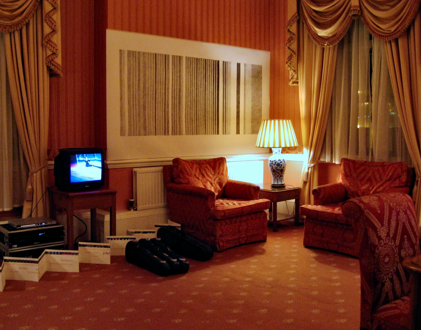 Installation view showing audio-visual equipment and documents arranged on the floor of a hotel suite, The George Hotel, Huddersfield, 2007