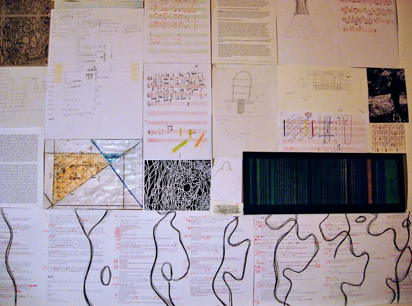 Wall of drawings, sketches and documents with curvilinear body outline drawings below, from The Soul Finds Rest in Unity