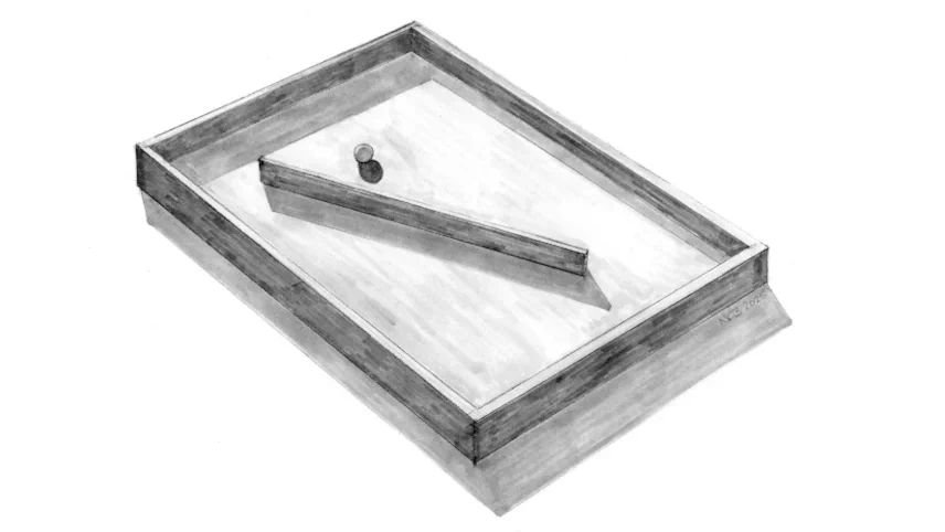 A pencil drawing of a shallow rectangular wooden tray viewed in perspective, containing a diagonal wooden batten and a small ball near one end, signed with initials in the lower right corner